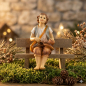 Preview: Handbemalte Krippenfigur Junge sitzend inkl. Bank, ca. 9 cm, K 001-28